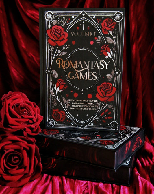 Romantasy Games box front and sprayed edges, surrounded by rich red velvet and red roses
