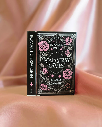 Romantic Expansion game box held against a soft pink fabric background